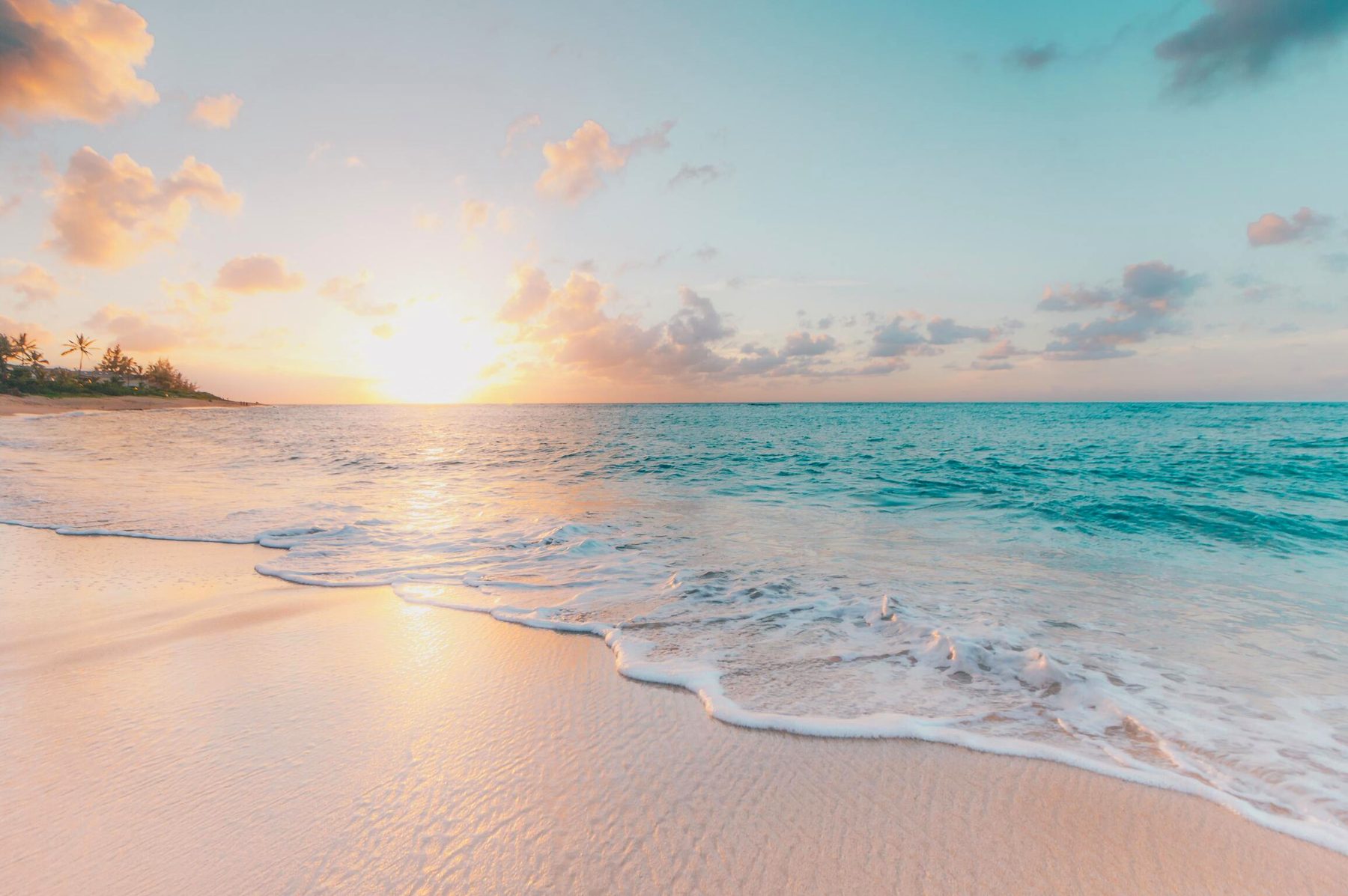 Waves rolling onto a beach at sunrise